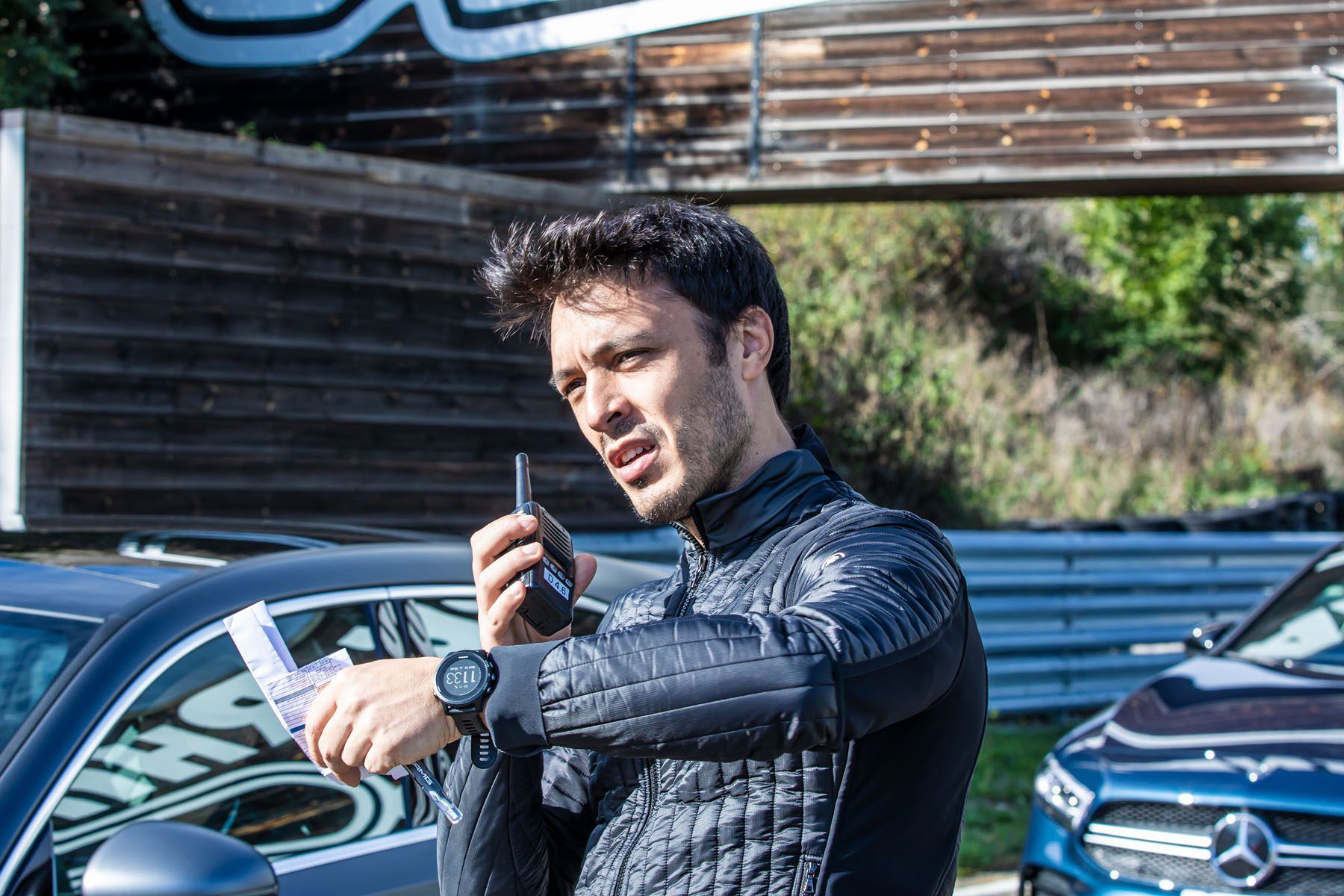 Instructor guiding drivers by radio at an AMG Performance Tour event